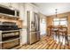 Open-concept kitchen features stainless steel appliances and adjacent dining area at 9609 Highgate N Cir, Indianapolis, IN 46250
