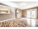 Open living room with hardwood floors, a view of the kitchen, and access to the backyard at 9609 Highgate N Cir, Indianapolis, IN 46250