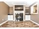 Cozy living room featuring a fireplace, built-in shelves, and a view to the kitchen at 9609 Highgate N Cir, Indianapolis, IN 46250