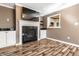 Inviting living room with a fireplace, built-in cabinets, and a pass-through to the kitchen at 9609 Highgate N Cir, Indianapolis, IN 46250