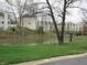 Exterior view of a pond near the residences, with mature trees and green grass, and 'No swimming' sign at 9609 Highgate N Cir, Indianapolis, IN 46250