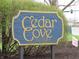 Community sign for Cedar Cove, with blue wood and gold lettering and trim at 9609 Highgate N Cir, Indianapolis, IN 46250