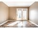 Bright sunroom features wood floors and double doors to the backyard for seamless indoor/outdoor living at 9609 Highgate N Cir, Indianapolis, IN 46250