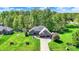 Aerial shot showcasing a stunning home with lush green lawn, mature trees, and a well-manicured landscape at 9879 Ruby Ct, Mooresville, IN 46158