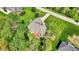 Aerial photograph of a home featuring a backyard with trees, lush grass, patio and meticulous landscaping at 9879 Ruby Ct, Mooresville, IN 46158