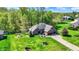 Aerial view of a beautiful home, expansive green lawn, and lush trees in a desirable neighborhood at 9879 Ruby Ct, Mooresville, IN 46158