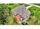 Aerial view of a home with a deck and patio surrounded by lush greenery and landscaping at 9879 Ruby Ct, Mooresville, IN 46158