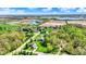 Scenic aerial view showcasing homes near a lake, complemented by vibrant trees and manicured lawns at 9879 Ruby Ct, Mooresville, IN 46158