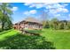 Well-maintained backyard with a brick home, wooden deck, and pergola; perfect for outdoor living at 9879 Ruby Ct, Mooresville, IN 46158