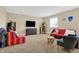 Finished basement area with a tv, furnishings, decor, window, and neutral carpet at 9879 Ruby Ct, Mooresville, IN 46158
