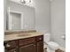 Powder room with a decorative vanity and countertop, along with a frameless mirror and classic fixtures at 9879 Ruby Ct, Mooresville, IN 46158