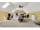 Bonus room with fan, skylights, neutral carpet, and built-ins, desk, tv, and furniture at 9879 Ruby Ct, Mooresville, IN 46158