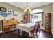 Bright dining room featuring a piano, hardwood floors, and a large window at 9879 Ruby Ct, Mooresville, IN 46158