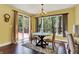 Bright dining room with backyard view, chandelier and hardwood flooring at 9879 Ruby Ct, Mooresville, IN 46158