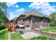 Back exterior view of a beautiful brick home with a wooden deck, patio, and landscaped yard at 9879 Ruby Ct, Mooresville, IN 46158