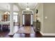 Elegant foyer featuring hardwood floors, decorative columns, and a stylish front door at 9879 Ruby Ct, Mooresville, IN 46158