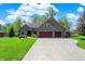 Charming brick home with a three-car garage and lovely landscaping at 9879 Ruby Ct, Mooresville, IN 46158