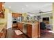 Open kitchen with granite countertops, stainless steel appliances, and hardwood floors flowing into the living room at 9879 Ruby Ct, Mooresville, IN 46158