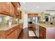 Spacious kitchen featuring wood cabinets, granite counters, stainless steel appliances, and hardwood floors at 9879 Ruby Ct, Mooresville, IN 46158
