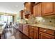 Gourmet kitchen with custom cabinetry, granite counters, and views of the dining area at 9879 Ruby Ct, Mooresville, IN 46158