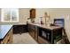 Basement kitchenette with microwave, sink, dark cabinets, decor, and window at 9879 Ruby Ct, Mooresville, IN 46158
