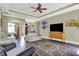 Spacious living room with a tray ceiling, dark hardwood floors, and comfortable seating at 9879 Ruby Ct, Mooresville, IN 46158