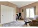 Comfortable living room features a closet, TV, and a floral chair at 9879 Ruby Ct, Mooresville, IN 46158