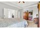 Spacious main bedroom featuring a tray ceiling, carpet floors, and ensuite bathroom entrance at 9879 Ruby Ct, Mooresville, IN 46158