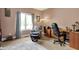 Spacious home office area with a desk, floral chair, and natural light at 9879 Ruby Ct, Mooresville, IN 46158