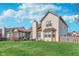 Well-maintained backyard showcasing the home's exterior, a screened porch, and a lush green lawn at 10518 Greenway Dr, Fishers, IN 46037