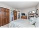 Cozy bedroom featuring striped bedding, wooden closet doors, and charming decorative touches at 10518 Greenway Dr, Fishers, IN 46037