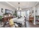 Bright dining room boasts large windows, elegant lighting, and beautiful furnishings at 10518 Greenway Dr, Fishers, IN 46037