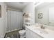 Bathroom with tub/shower, storage shelf, wood look flooring and a vanity with an integrated sink at 10876 Bellflower Ct, Indianapolis, IN 46235