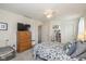 Comfortable bedroom with warm lighting, functional furniture, and a ceiling fan for added comfort at 10876 Bellflower Ct, Indianapolis, IN 46235