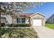 Charming single-Gathering home with a brick facade and blossoming tree in the front yard at 10876 Bellflower Ct, Indianapolis, IN 46235