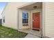 Inviting home entrance featuring a red front door with wreath, flower box, and a 'Welcome' mat at 10876 Bellflower Ct, Indianapolis, IN 46235