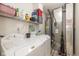 Functional laundry room featuring a washer, dryer, shelving, and linoleum flooring at 10876 Bellflower Ct, Indianapolis, IN 46235