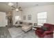 Inviting living room with comfortable seating, a ceiling fan, and a skylight for ample natural light at 10876 Bellflower Ct, Indianapolis, IN 46235