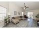 Comfortable living room with large sectional sofa, ceiling fan and sliding glass doors to patio at 10876 Bellflower Ct, Indianapolis, IN 46235