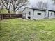 Spacious backyard with a dark wooden fence and potential area for outdoor entertaining at 122 Southlane Dr, New Whiteland, IN 46184