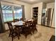 Inviting kitchen with stainless steel refrigerator, pantry, and a dining area with ample sunlight at 122 Southlane Dr, New Whiteland, IN 46184