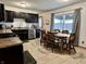 Well-lit kitchen with stainless steel appliances, dark cabinets, and a view of the backyard at 122 Southlane Dr, New Whiteland, IN 46184