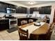 Cozy kitchen featuring dark cabinets, stainless steel appliances, and an adjacent dining area at 122 Southlane Dr, New Whiteland, IN 46184
