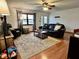 Cozy living room with hardwood floors, a ceiling fan, and comfortable seating area at 122 Southlane Dr, New Whiteland, IN 46184