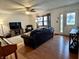 Bright living room featuring hardwood floors, a ceiling fan, and comfortable seating at 122 Southlane Dr, New Whiteland, IN 46184