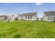 The backyard offers plenty of space for outdoor activities with lawn and Adirondack chairs at 12223 Split Granite Dr, Fishers, IN 46037