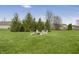 A lush backyard provides a relaxing retreat with mature trees and lawn at 12223 Split Granite Dr, Fishers, IN 46037