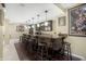 Basement bar features dark wood cabinets, counter seating, pendant lighting, and hardwood floors at 12223 Split Granite Dr, Fishers, IN 46037