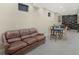 Spacious basement with a brown leather sofa, a game table with chairs, and a bookcase at 12223 Split Granite Dr, Fishers, IN 46037
