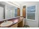 Bathroom with double sink vanity, large mirror, and shower with glass door at 12223 Split Granite Dr, Fishers, IN 46037
